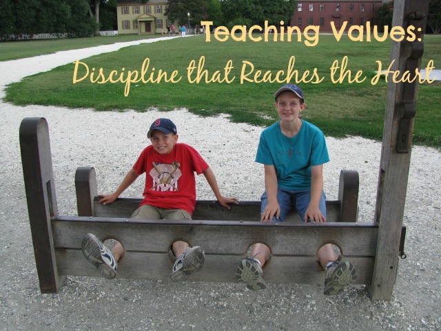 Kids posing in stocks in historic Williamsburg, VA. For a blog post about teaching heartfelt discipline.