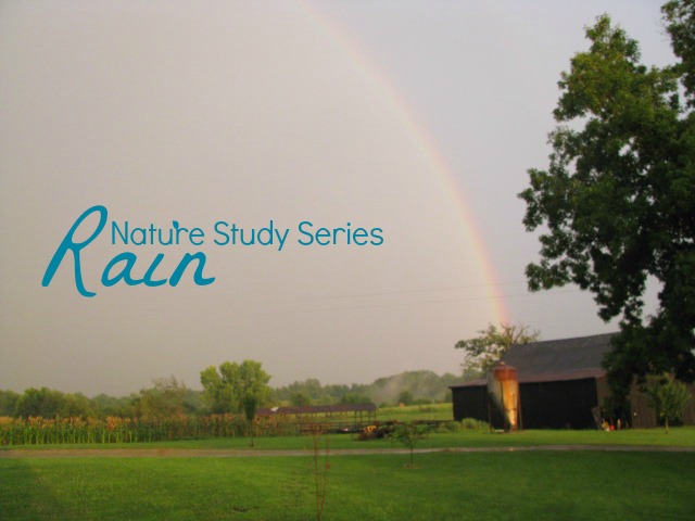 Rainbow in a dark sky that ends into a black barn. For a nature series about rain.