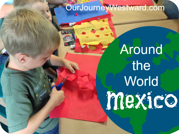 boy cuts out red tissue paper to make a flag. For a blog image about Around the World: Mexico.