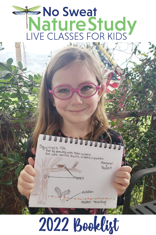 Girl with pink glasses holding up a nature journal page about squirrels.