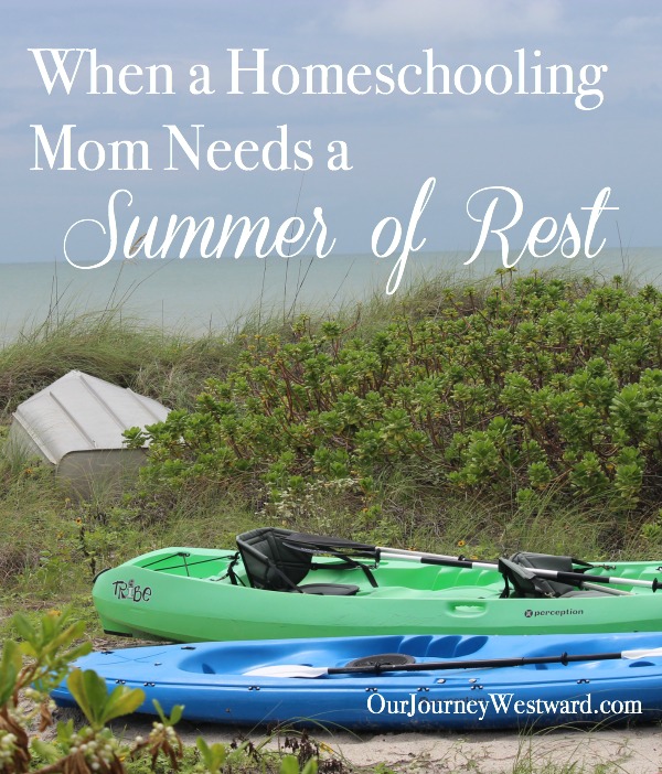 Green and blue kayaks and a boat sitting on the sand in between beach foliage. Photo is used for a blog post on homeschooling moms needing summer rest.